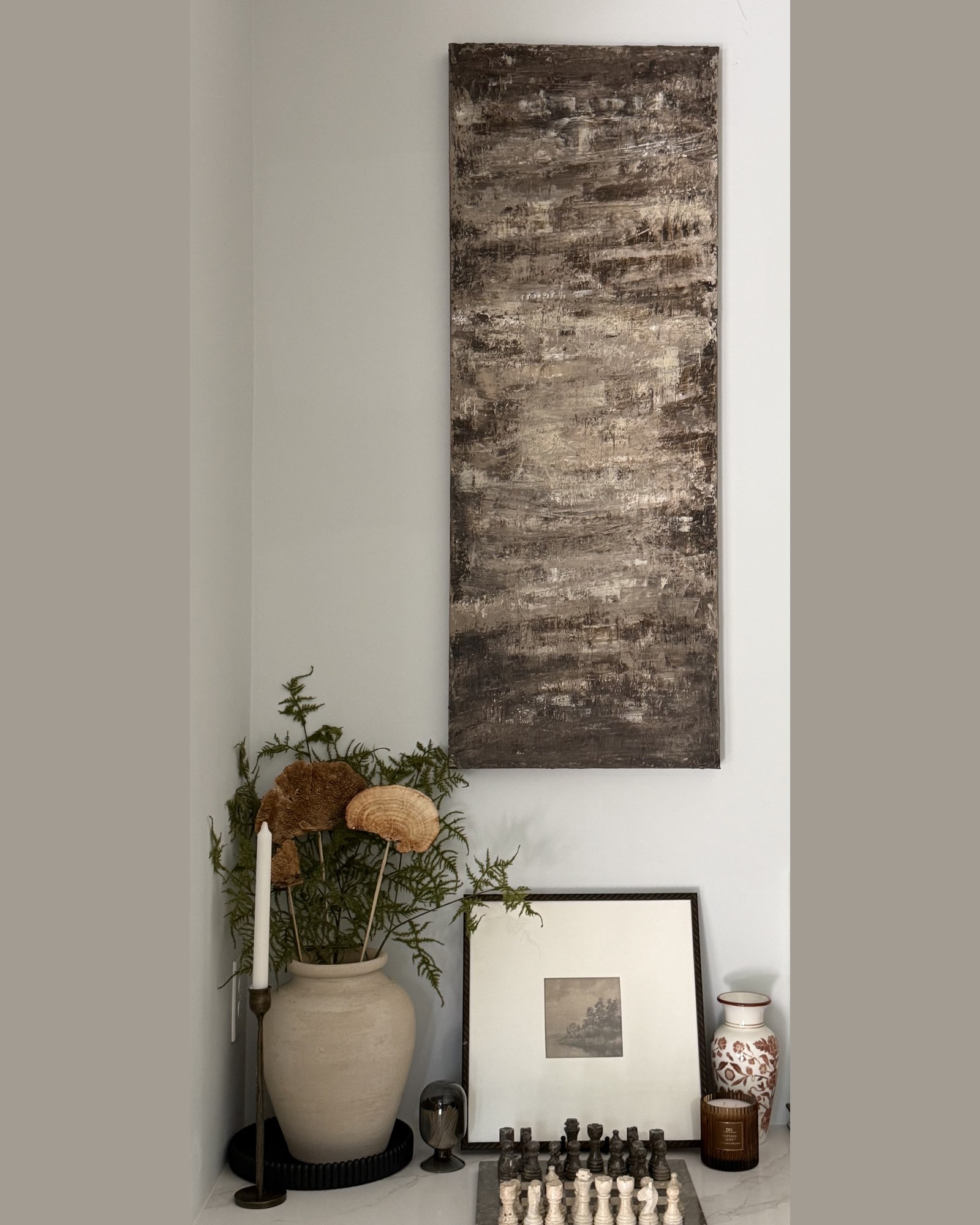 Birch, a tall textured painting, hung in a styled corner of a home